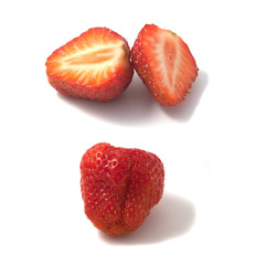 Fresh strawberries. One halved. Macro photo.