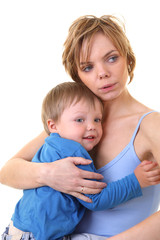 young little son embracing his pretty young mother