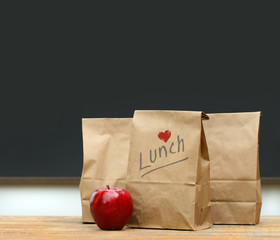 Lunch bags with  apple on school desk - 14920514