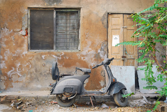 scooter and grunge wall in india
