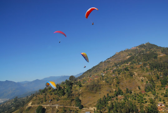 4 paragliders with himalaya view in nepal