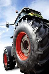 Perfect new tractor on sky background with clipping path