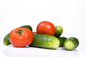 Cucumbers and tomato, isolated on white background