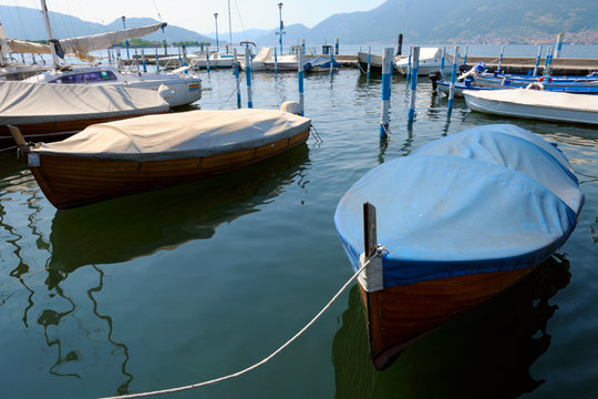 Covered boats moored in the marina at Iseo, Lombardy, Italy