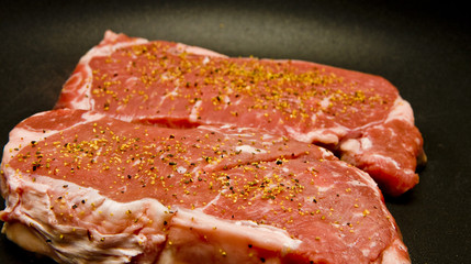 Seasoned Strip Steaks in Pan