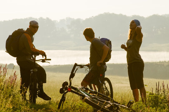 cyclists at sunset
