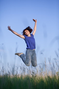 woman jumping in grass