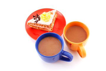 closeup of slice of tasty cake and coffee cups