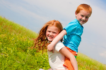 Fototapeta premium Two fan children playing on the field