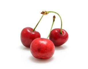 three red cherries isolated on white background