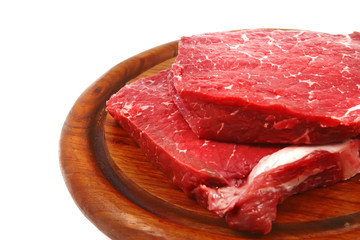 raw meat on wooden plate
