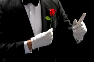 young magician performing red rose