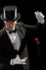young magician performing red rose