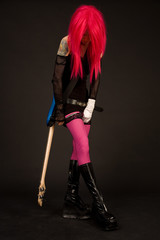 Attractive girl with guitar putting on stocking