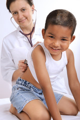 female doctor examining little child boy