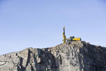 Crane on a mountain towards blue sky