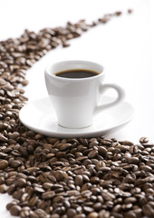Coffee cup and grain on white background
