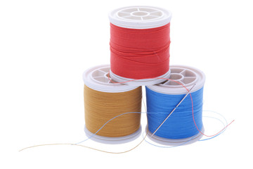 three plastic reels with sewing thread