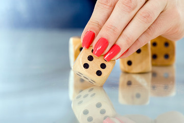 female touching dice with her finger 3