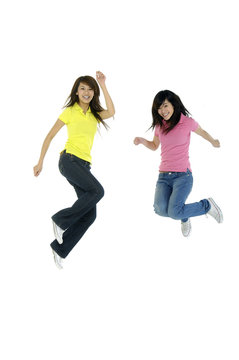 Girls Jump In Studio On A White Background