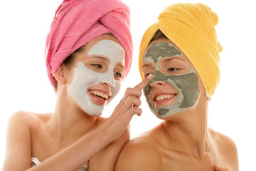 Two teenage girl applying facial cream