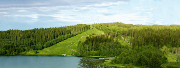 Landscape with green hills and lake