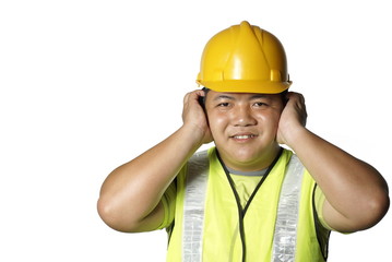 Asian construction worker covering ears