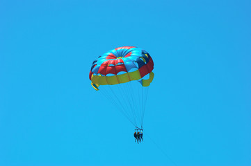 three people parasailing