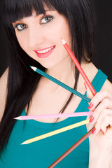young woman with varicolored pencils