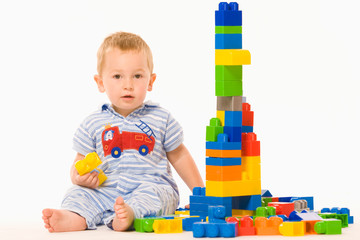 Little boy playing constructor