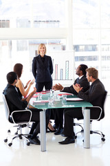Businesspeople clapping in a meeting