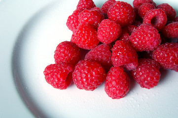 Raspberries on white plate