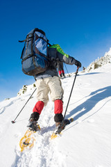 Hiker in winter in mountains