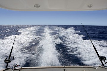 Fishing rod and reel on boat  in blue ocean