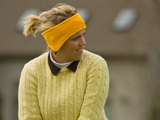 Female golfer addressing the golf ball