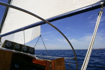 Sailboat sailing blue sea on sunny summer day