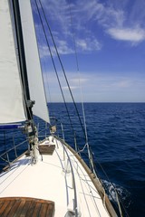 Sailboat sailing blue sea on sunny summer day