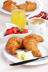 Full French breakfast with croissants, fruits, jam and coffee