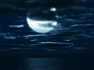 moon in darkness on a background of the sea