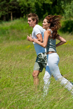 Sportive couple jogging in the nature