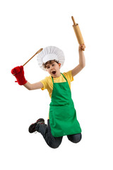 Boy holding kitchenware jumping isolated on white