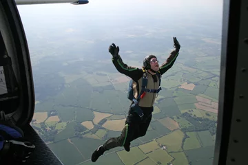 Tuinposter Student skydiver jumps from an airplane © Joggie Botma