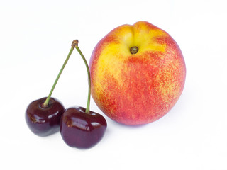 Peach and cherrys on a white background.