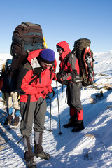 Hikers are in winter in mountains