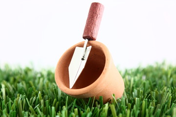plant pot with trowel on grass