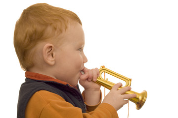 Young boy playing toy trumpet