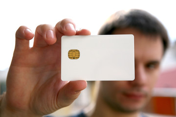 man holding a blank id card with chip