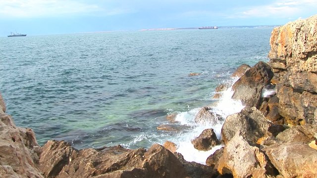 Waves fight about rocks in Black sea for a background