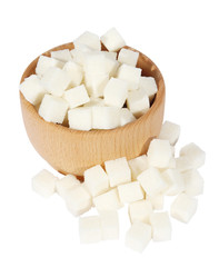 Lump sugar in a wooden mortar on a white background