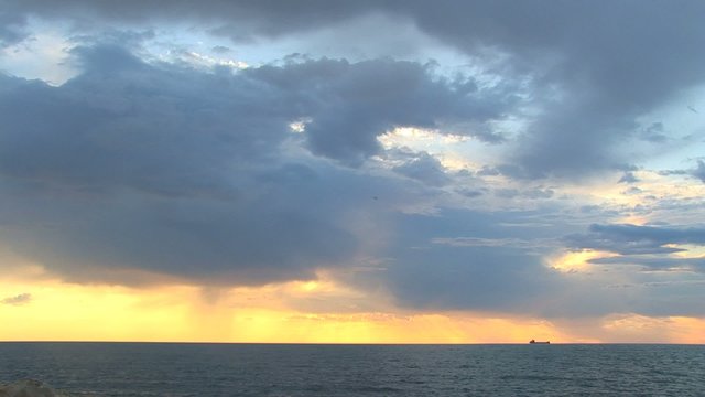 Sunset against the black sea for a background